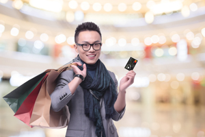 Young guys shopping in mall with credit card